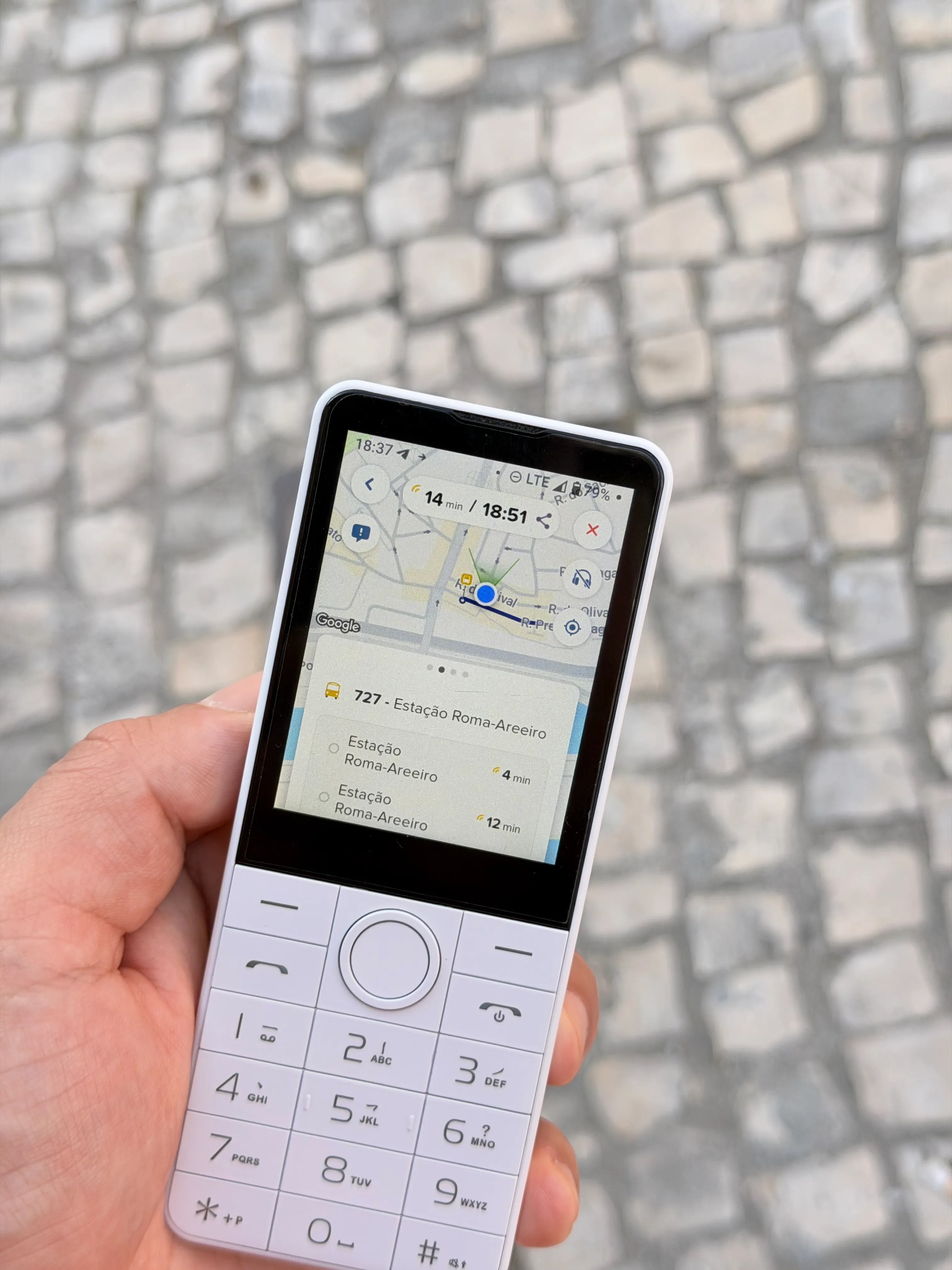 Doov R77 held outdoors, showing a bus route in Citymapper.